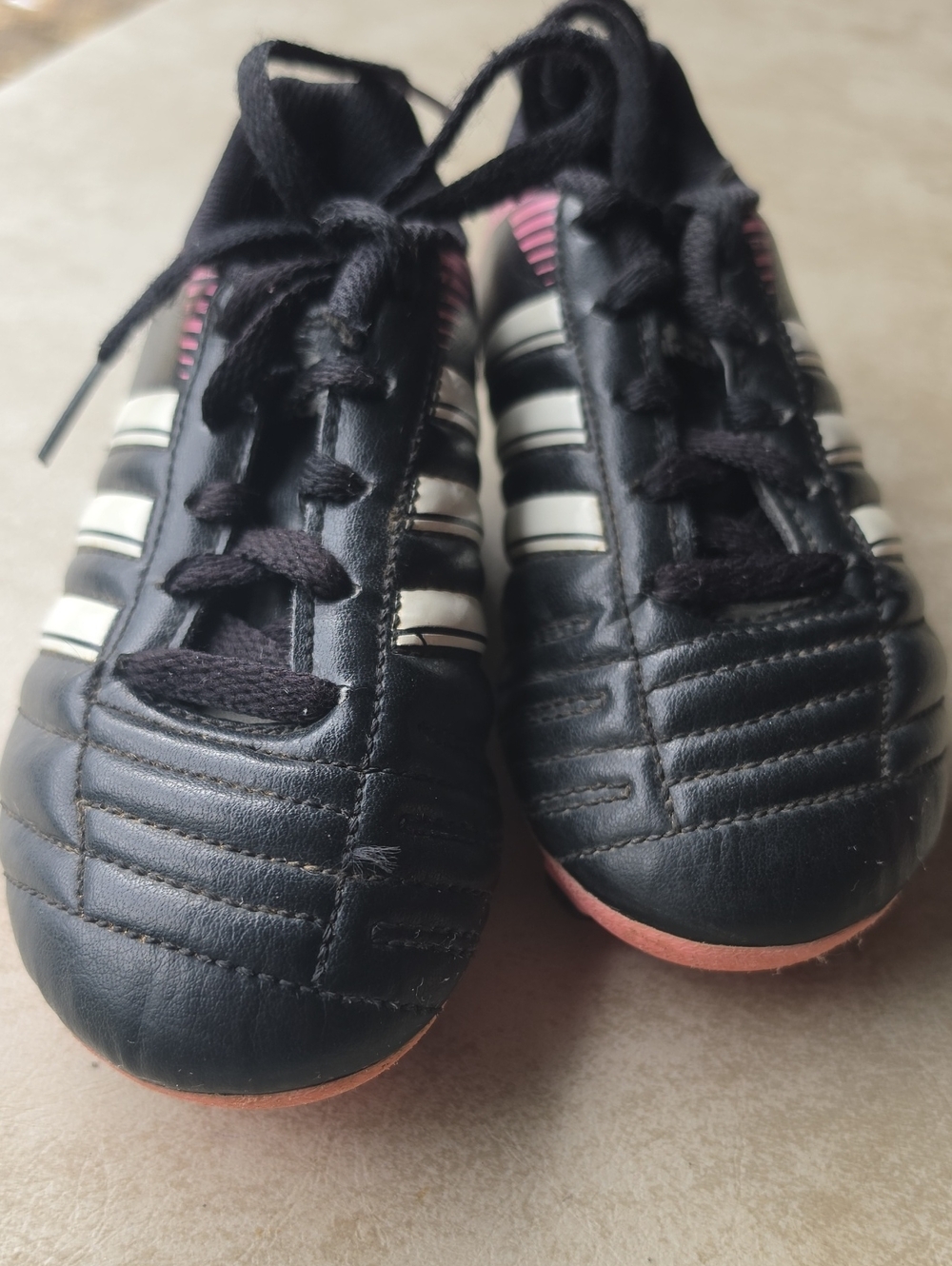 Adidas Black Soccer Cleats with White Stripes and Pink Soles